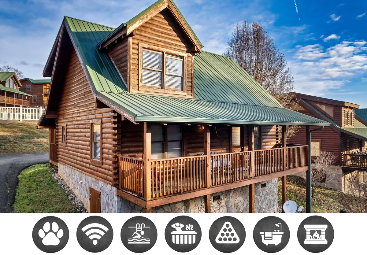 The image showcases a charming log cabin with a distinctive green metal roof and spacious wooden balcony, set against the lush landscape of Pigeon Forge. The inviting porch suggests a perfect spot for morning coffee, while the balcony promises memorable moments of stargazing and relaxation. The cabin's rustic appeal and natural surroundings create a cozy, welcoming atmosphere ideal for families or friends seeking a getaway.
